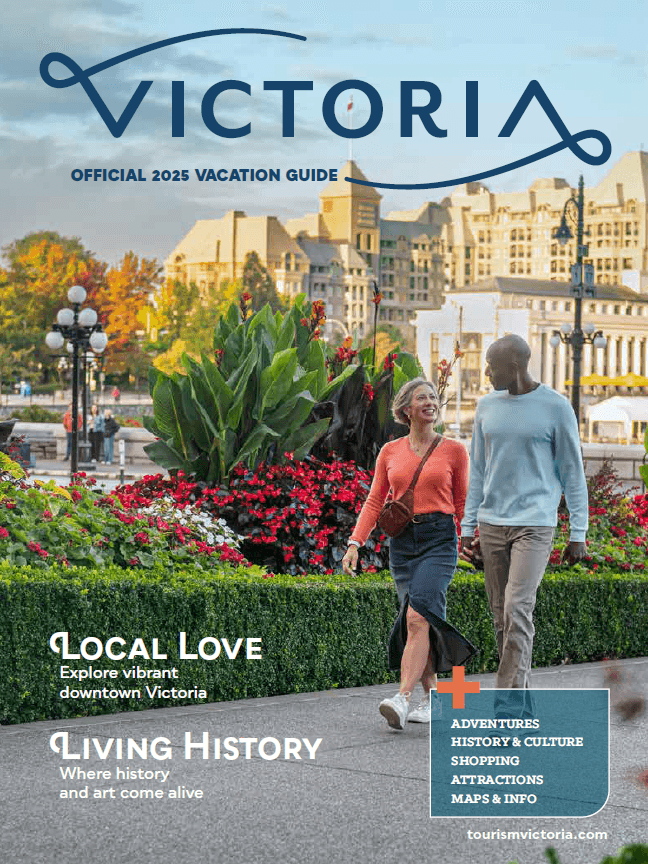 A couple walks along a pathway at the Fairmont Empress in Victoria, BC on the cover the 2025 Victoria Vacation Guide